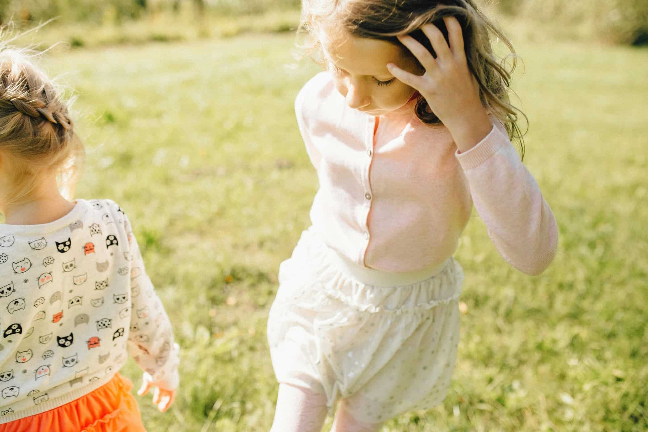 two girl walking on the gras